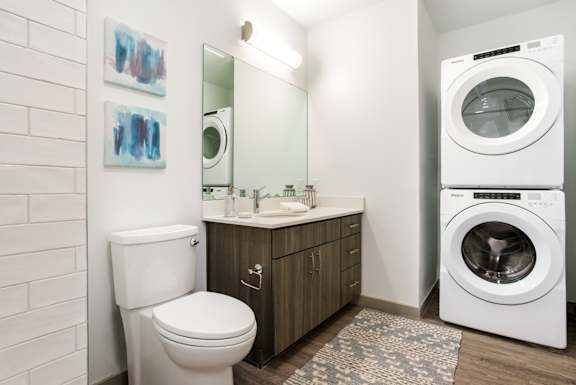 A white toilet sits next to a sink in a small bathroom.