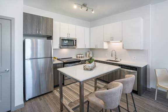 A modern kitchen with a table and chairs.