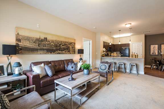 A living room with a brown couch and a coffee table.