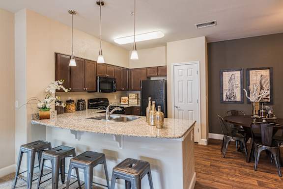 A kitchen with a bar area and a dining table.