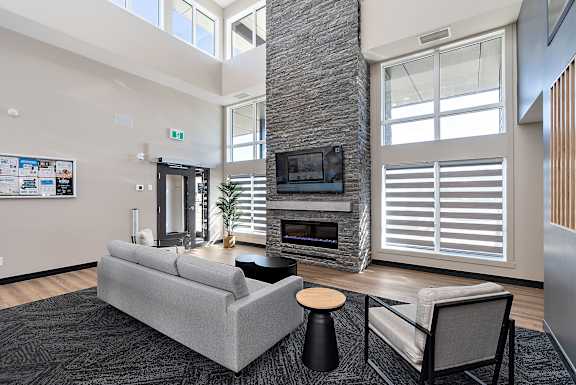 a living room with a gray couch and a fireplace