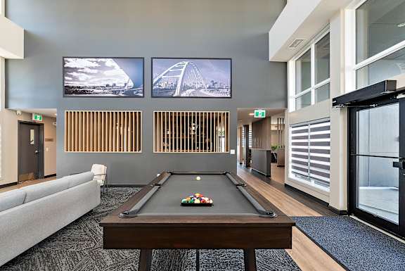 a games room with a pool table and a television