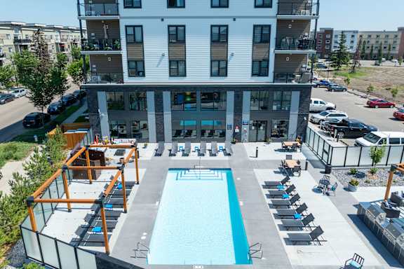 A large building with a pool in front.