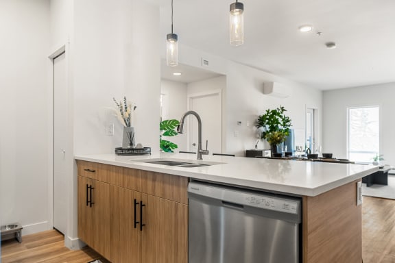 a kitchen with an island and a stainless steel dishwasher