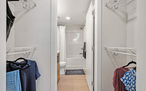 A white bathroom with a toilet, sink, and shower.