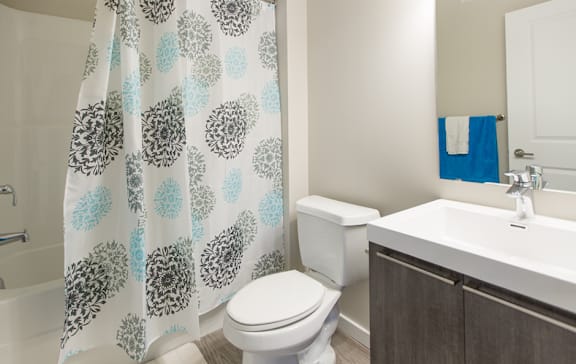 A white toilet sits next to a sink in a bathroom.