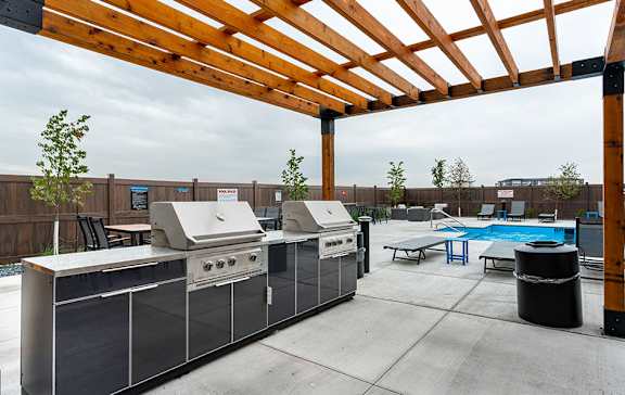 A patio with a grill and a pool table.