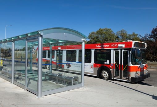 Public transit bus stop with glass shelter at Mac and Mullen Apartments, Edmonton