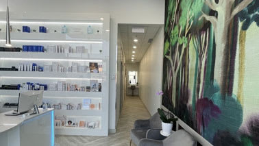 A brightly lit office with a mural on the wall.