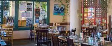 A restaurant with tables and chairs set up for dining.