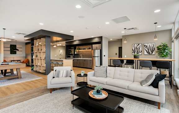 A modern living room with a white sofa and a coffee table.