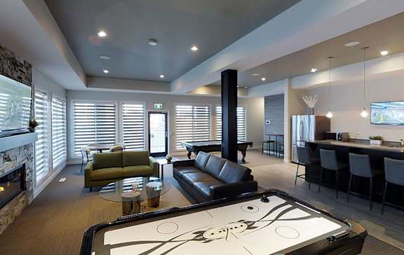 A billiard table is in the middle of a modern living room.