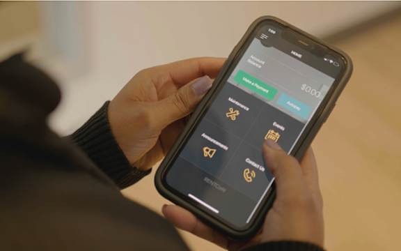 A person holding a phone with a screen displaying a list of options.at Latitude 49 Townhomes, Winnipeg Manitoba