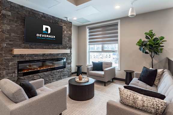 Modern lounge with fireplace and seating area at Mac and Mullen Apartments, Edmonton, AB T6R 0S7