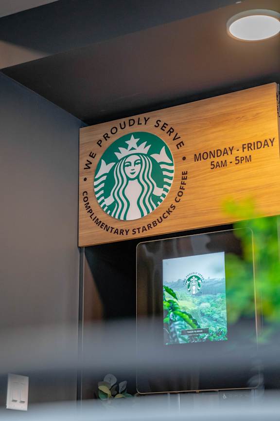 Starbucks coffee kiosk with operating hours at Mac and Mullen Apartments, Edmonton, T6R 0S7