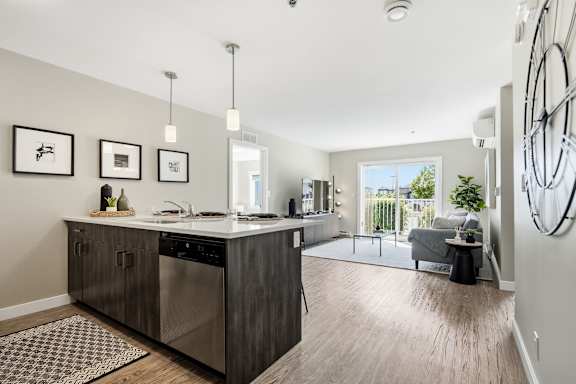 A modern kitchen with a large island and a view of the backyard.