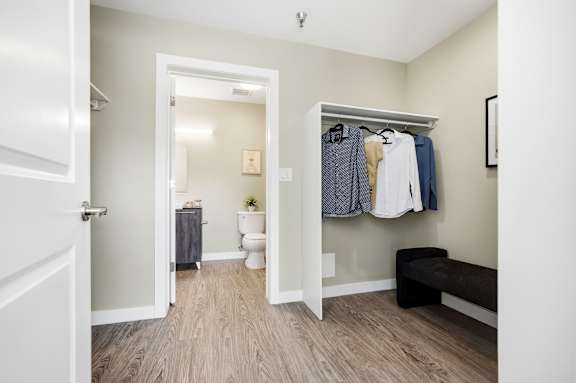 A small room with a toilet and a bench.