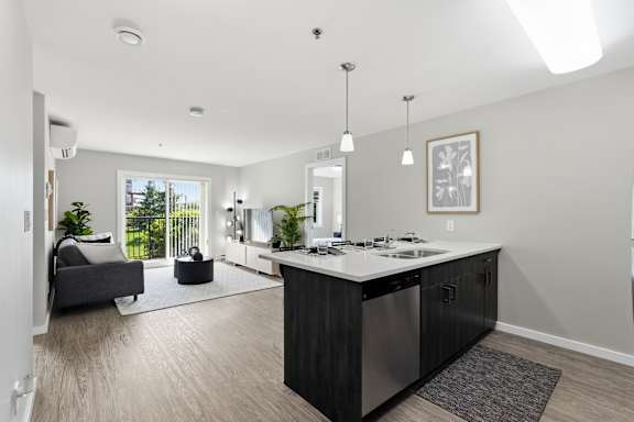 A modern kitchen with a large island and a view of the backyard.