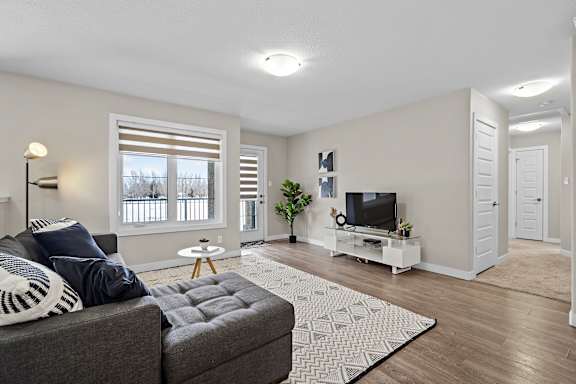 A living room with a grey couch and a television.
