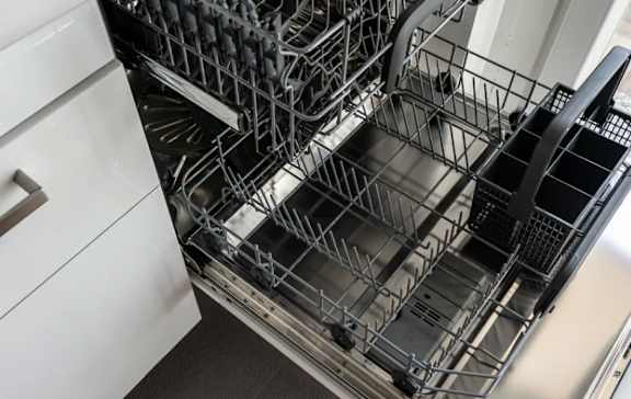 A dishwasher with its racks open.