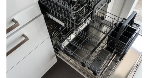 a dishwasher in a kitchen next to a cabinet at Vibe Apartments at Arbour Lake in Calgary, AB, T3G 4J2