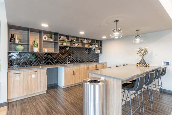 Open concept kitchen with island and bar seating at Mac and Mullen Apartments, Alberta, T6R 0S7
