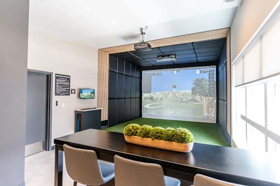 A modern dining room with a large table and chairs.