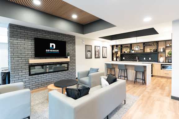 A modern living room with a brick fireplace and a television displaying the word "DEVERAUX".
