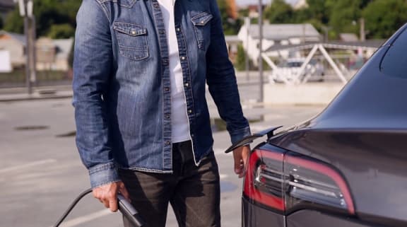 a man holding the trunk of a car