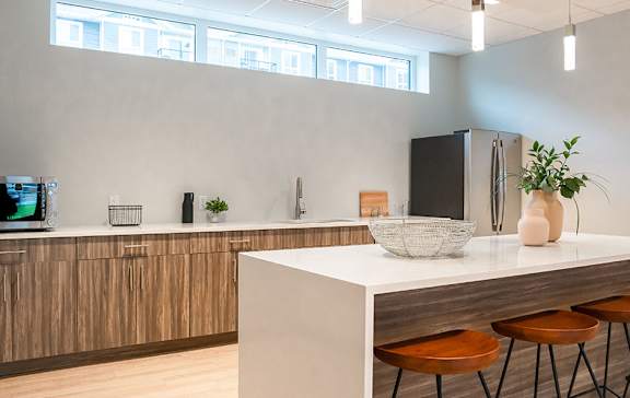 A modern kitchen with wooden cabinets and a white countertop.