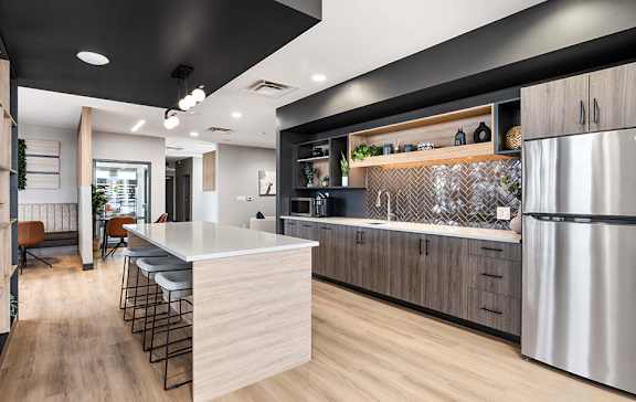 A modern kitchen with a large island and stainless steel appliances.