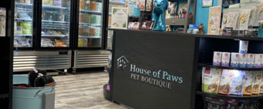 A pet store with a sign that says House of Paws Pet Boutique.