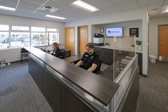 Two office workers sitting at a desk in an office at Raymond Block, Edmonton