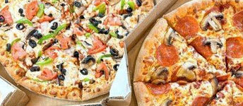 Two pizzas, one with pepperoni and mushrooms, the other with tomatoes and black olives.