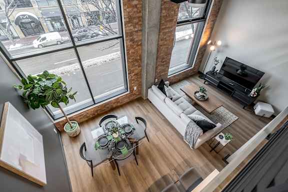 A living room with a glass table and a white couch.at Raymond Block, Alberta, T6E 3R7