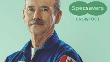 A man in a blue uniform with a Canadian flag patch on his chest.