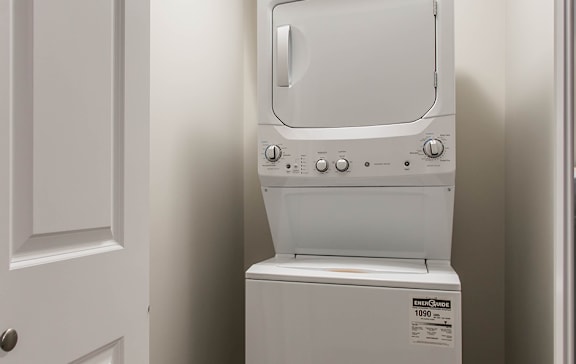 A white washing machine and dryer in a small laundry room.