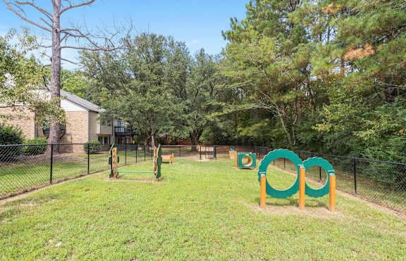A playground with a green and yellow swing set at The Onyx Hoover Apartments, Hoover, AL