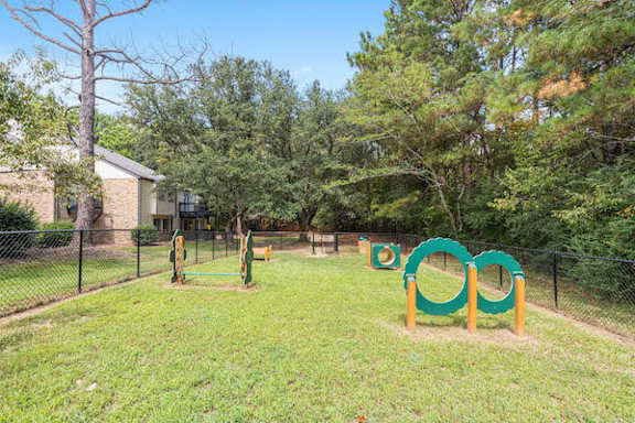 A playground with a green and yellow slide at The Onyx Hoover Apartments, Hoover, AL