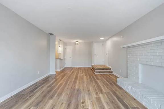 A room with wooden flooring and white walls at The Onyx Hoover Apartments, Hoover, Alabama