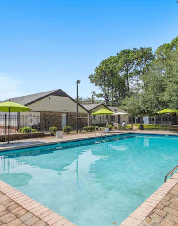 A swimming pool surrounded by a brick border at The Onyx Hoover Apartments, Hoover, AL, 35216