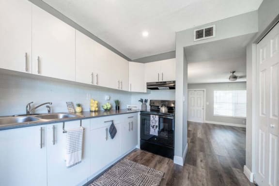 a kitchen with a stove top oven next to a sink at Piper Village West, Florida