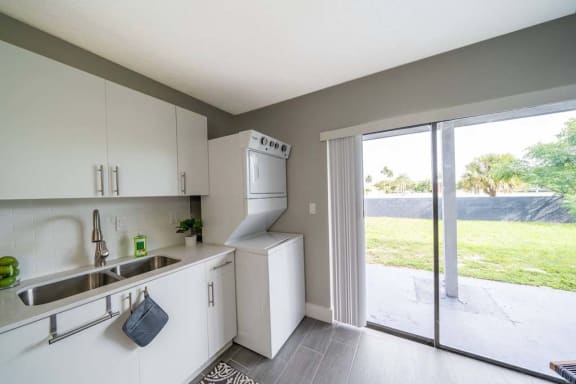 a kitchen with a sink and a washer and dryer at Piper Village West, Florida
