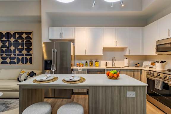 A modern kitchen with a dining table set for two.at Icon One, Florida