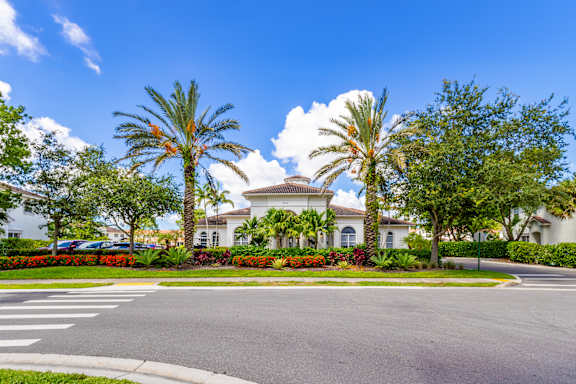 Large white house with a palm tree in front at The Falls of Portofino , Naples, FL, 34119
