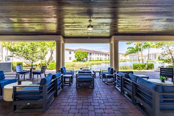 Patio with blue chairs and tables at Portofino Cove, Florida, 33916