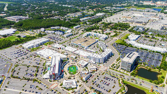 An aerial view of a large city with a mix of buildings and green spaces.at Icon One, Florida, 32114