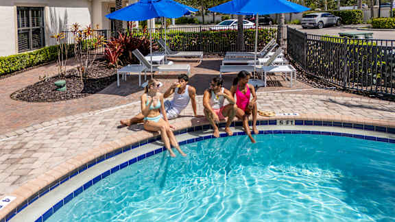 Three women sunbathing at Portofino Cove, Fort Myers, 33916