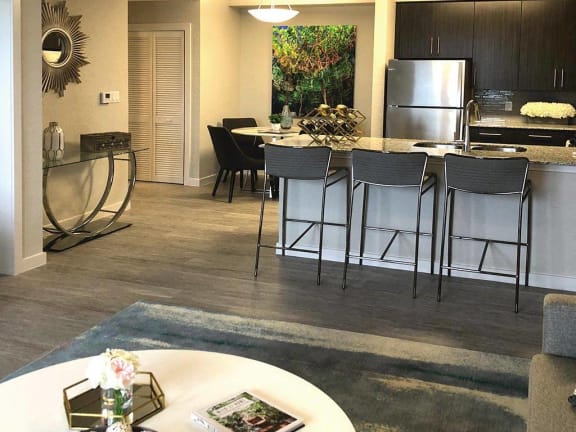 an open kitchen and dining area with bar stools at Icon One, Daytona Beach