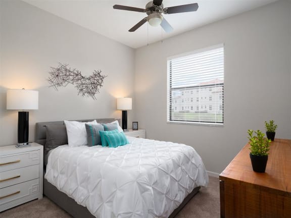 a bedroom with a white bed and a ceiling fan at Portofino Cove, Fort Myers, FL
